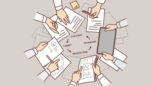 Hands of people over table with documents doing teamwork and strategizing during brainstorming